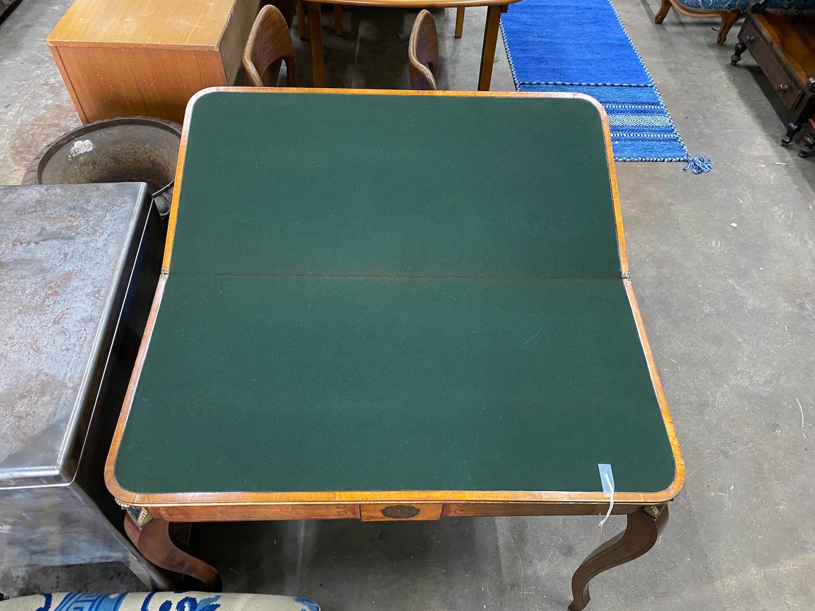 A Regency coromandel banded mahogany folding card table with parcel gilt Egyptianesque metal mounts, width 90cm, depth 44cm, height 75cm